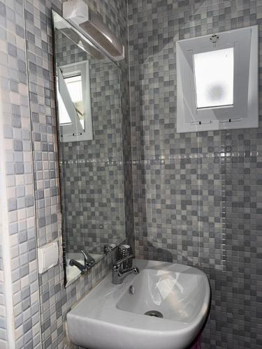 a bathroom with a sink and a mirror at Mini Paradise Fnideq in Fnidek