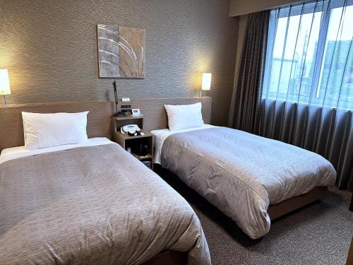 Cama o camas de una habitación en Hotel Route-Inn Katori Sawara Ekimae