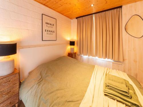 a small bedroom with a bed and a window at Chalet in Hastière near Freÿr Castle in Blaimont
