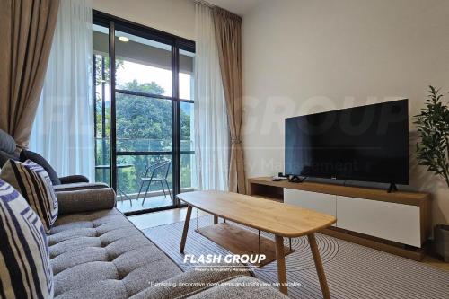 a living room with a couch and a tv and a table at Enclave Nature Suites @ Bukit Tinggi in Bentong