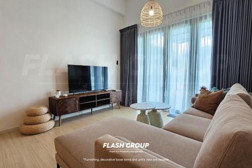 a living room with a couch and a tv at Enclave Nature Suites @ Bukit Tinggi in Bentong