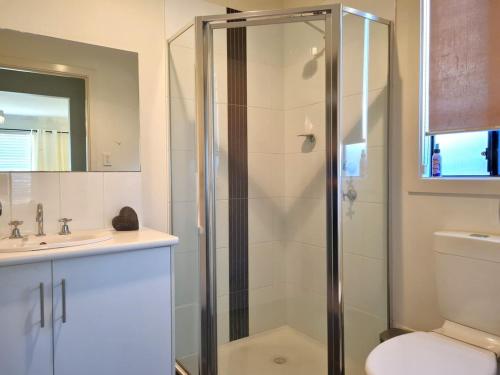 a bathroom with a shower and a toilet and a sink at Drift in Moonta