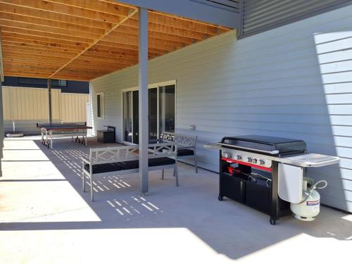 a outdoor patio with a grill and a picnic table at Horizons in Port Hughes