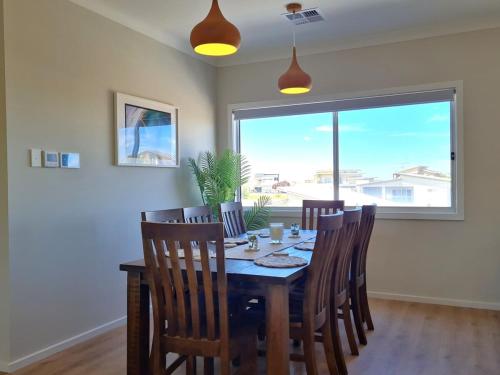 a dining room with a table and chairs and a window at Horizons in Port Hughes