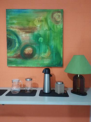 a table with a lamp and a tea kettle on it at IDEA Hotel Confort in Piracicaba