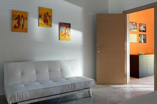 a living room with a white couch in a room at Casa Letizia in Porto Cesareo