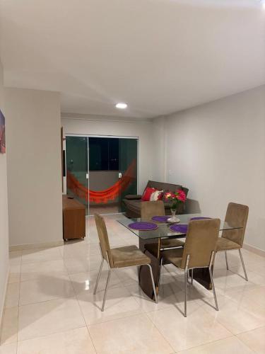 a living room with a table and chairs and a couch at Apto de 3 Quartos Vista lateral do Mar a 2km da praia do Araçagy in São Luís