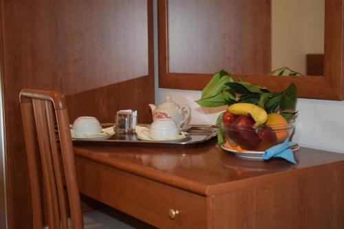 a table with a bowl of fruit on top of it at Hotel Astoria in Pesaro