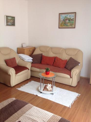 a living room with two couches and a table at Ana Tudor Apartments in Hvar