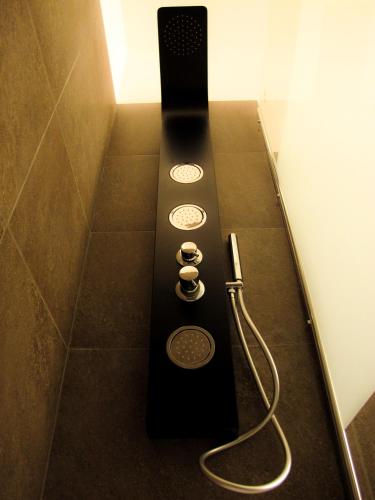 a black remote control sitting on the floor in a bathroom at Roma Veneto Relais in Rome