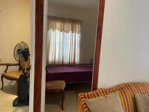 a reflection of a bedroom with a bed and a mirror at House in paquera in Tapantí