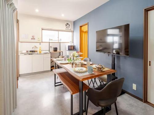 a kitchen and dining room with a table and chairs at 402 Newly opened Hotel Baika Family friendly Free parking 10 minutes to USJ in Osaka