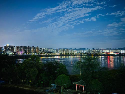 a view of a city with a river and buildings at Chongqing Jiayu Emperor Hotel in Jiulongpo