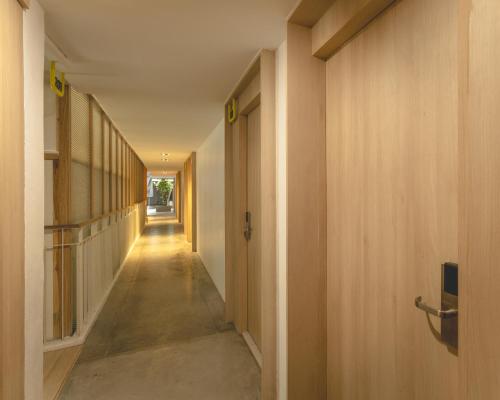 a corridor of a hallway with wooden walls and a hallway at jasminespace in Khlong San