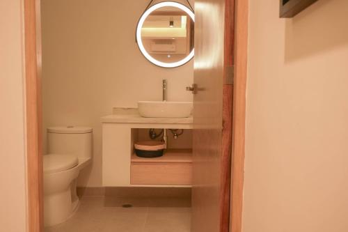 a bathroom with a sink and a mirror at Macondo Quinta Avenida Residences in Playa del Carmen