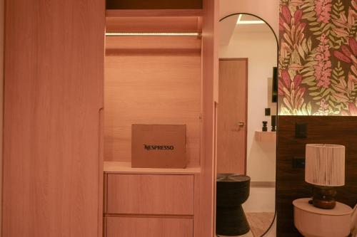 a box is sitting on a shelf in a room at Macondo Quinta Avenida Residences in Playa del Carmen