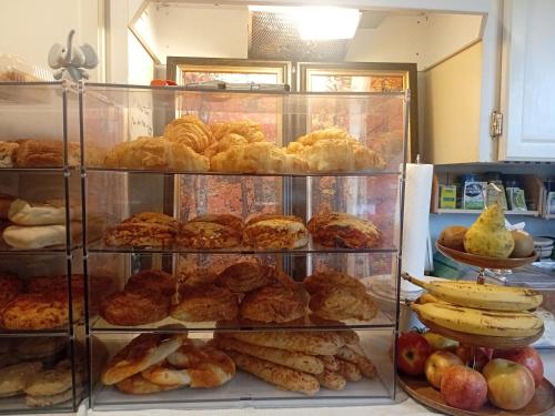 a display case filled with different types of pastries at Bed And Breakfast In Fraser Valley R2 - R3 in Abbotsford