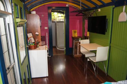 a kitchen with a table and chairs in a room at South Terrace Studio - Walk to Everything ! in South Fremantle