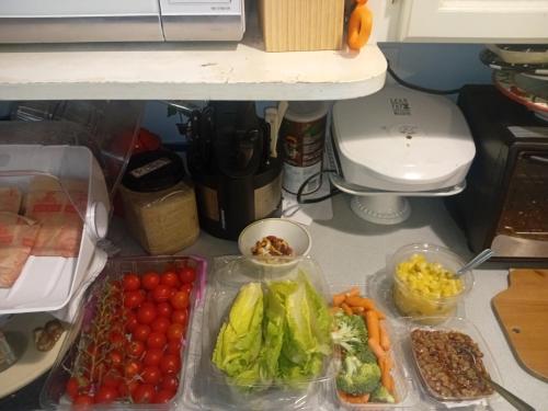 a refrigerator filled with different types of vegetables on a counter at Bed And Breakfast In Fraser Valley R2 - R3 in Abbotsford