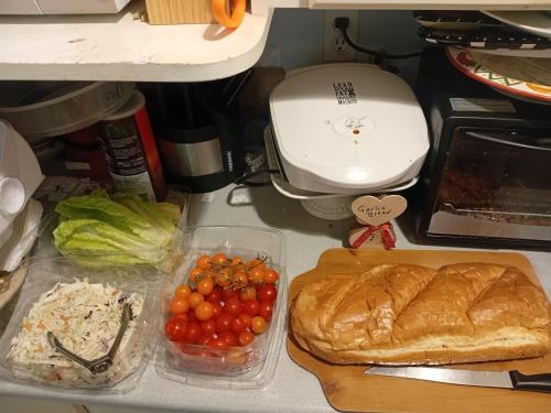 a counter top with a bunch of tomatoes and bread at Bed And Breakfast In Fraser Valley R2 - R3 in Abbotsford