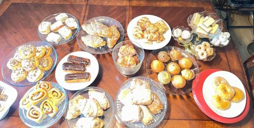 a table full of different types of pastries and cookies at Bed And Breakfast In Fraser Valley R2 - R3 in Abbotsford