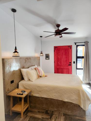 a bedroom with a large bed with a red door at Habitación tipo Look Off in La Paz
