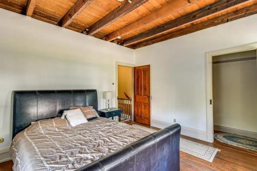 a bedroom with a large bed with a leather headboard at Historic Main Street Getaway 