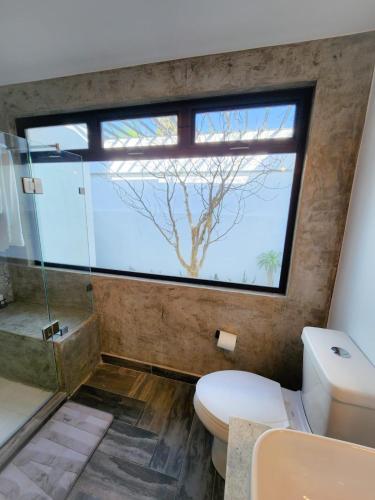a bathroom with a shower and a toilet and a window at Habitación tipo Look Off in La Paz