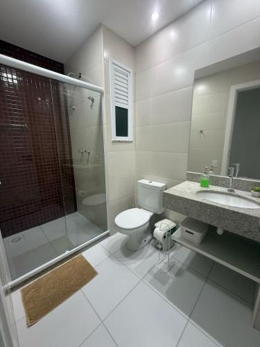a bathroom with a toilet and a shower and a sink at Arraial do Cabo RJ - Golden Lake in Arraial do Cabo