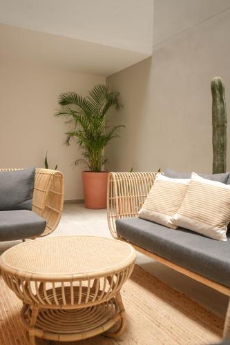 a living room with a couch and a table at Macondo Quinta Avenida Residences in Playa del Carmen