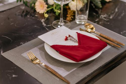a table with a plate with a red napkin on it at FTE Ba Dinh Hotel in Hanoi