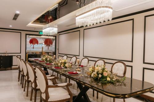 a long dining room with a long table and chairs at FTE Ba Dinh Hotel in Hanoi