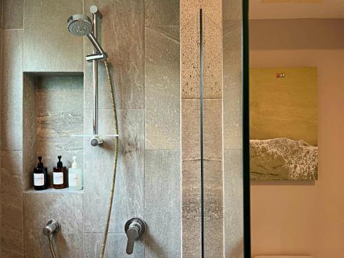 a shower with a glass door in a bathroom at Elan at Ballena Beach in Uvita