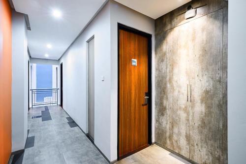 a hallway with a wooden door and a balcony at Bale Resident in Jakarta