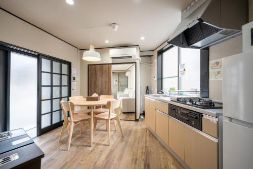 a kitchen and dining room with a table and chairs at Familia Heiwajima in Tokyo