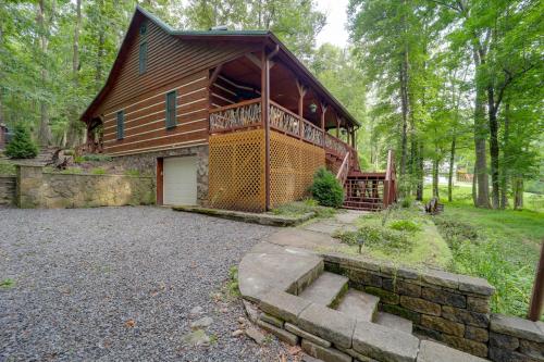 a large wooden house in the woods with a garage at Family-Friendly Blue Ridge Cabin with Game Room! in Fleetwood