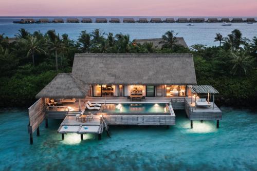 a villa in the water with a swimming pool at Waldorf Astoria Maldives Ithaafushi in South Male Atoll