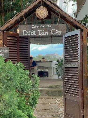a sign for a dildo tan guy in a garden at Horizon Home - Netflix n Chill in Ho Chi Minh City
