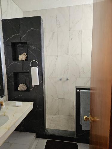 a bathroom with a shower and a sink at Cantamar 401, huge condo , incredible views, Sargassum Free in Cozumel