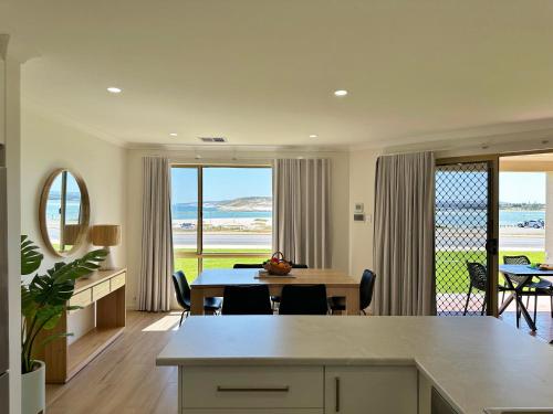 a kitchen and dining room with a table and a view at Pelican Shore Villa 4 - Kalbarri WA in Kalbarri