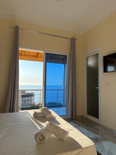 a bedroom with a bed with towels on it at Villa Evelyn Free Parking in Vlorë