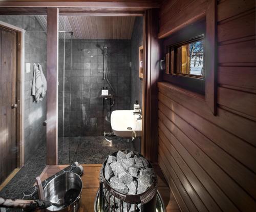 a bathroom with a sink and a shower at Tundrea Holiday Resort in Kilpisjärvi