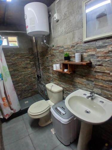 a bathroom with a toilet and a sink at Escapada ideal privada y cerca del Rio Con todo in Aguas Corrientes