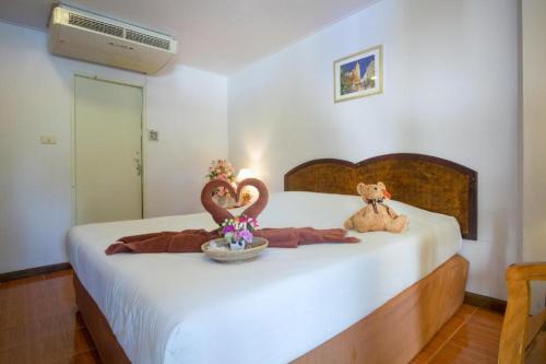 a bedroom with a bed with two stuffed animals on it at Cha Am Villa Beach in Cha Am