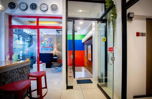 a restaurant with colorful walls and a glass door at Hotel Monde in Dagupan