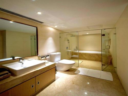 a bathroom with a sink and a toilet and a shower at Xian Elegant Oriental Hotel in Xi'an