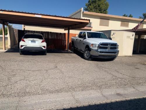 a truck and a car parked in a garage at Convenient place in Phoenix in Phoenix