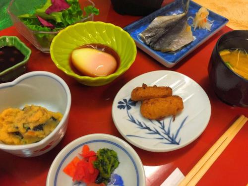 a table topped with plates of food and chopsticks at Kirishima Onsen Ryokojin Sanso in Kirishima