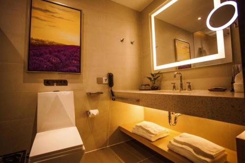 a bathroom with a sink and a mirror at Beijing Lavande Hotel Shunyi Subway Station Branch in Beijing