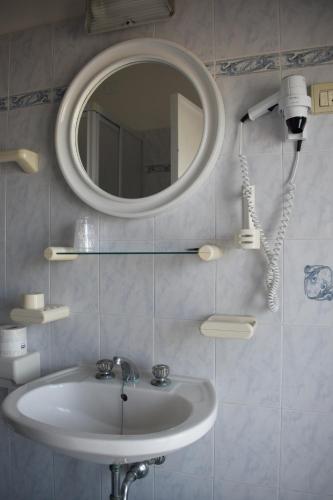 a bathroom with a sink and a mirror at Hotel Astoria in Pesaro
